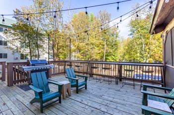 Backyard Deck with Adirondack Chairs & Grill